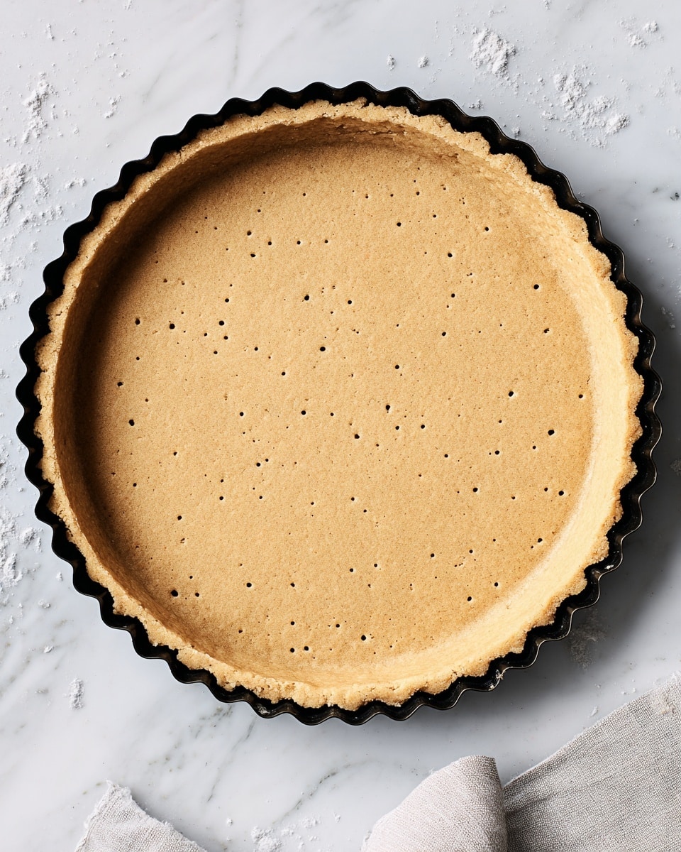 A white plate with a yellow and green pattern around the edge holds a dish with three clear layers. The bottom layer is light yellow cooked spaghetti, thick and twisted. Above the spaghetti is a layer of rich red tomato sauce that looks chunky and fresh. The top layer has melted white cheese that is slightly browned and sprinkled with small green herbs. The plate is on a white marbled surface and there is a pan with sauce blurred in the background. photo taken with an iphone --ar 4:5 --v 7