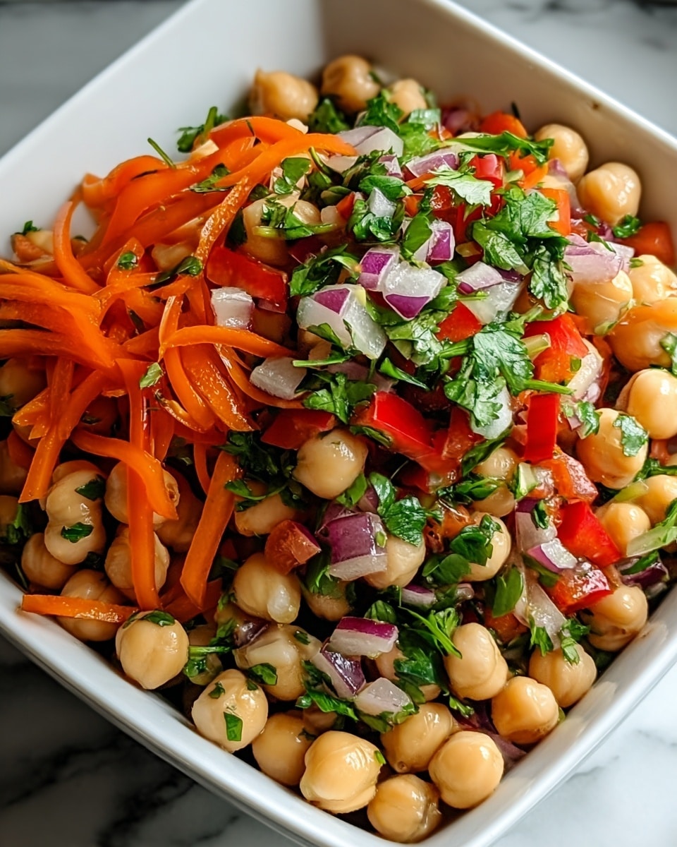 A close-up image of a chickpea salad served in a deep white square bowl, filled with three main layers: a base layer of light beige chickpeas, a middle layer of thinly sliced bright orange carrots and red bell peppers, and a top layer of chopped fresh green cilantro and small pieces of purple onion, all mixed together in a colorful, fresh, and glossy arrangement, sitting on a white marbled surface. photo taken with an iphone --ar 4:5 --v 7