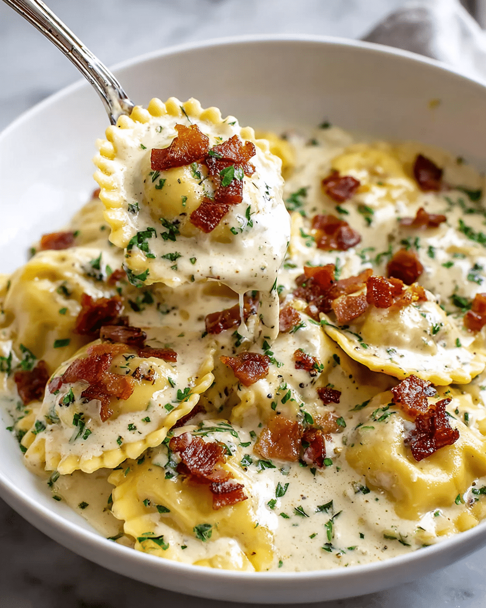 A white bowl filled with round ravioli pasta covered in creamy white sauce, topped with small crispy brown bacon pieces and finely chopped green herbs scattered evenly. The ravioli have a light yellow color and ruffled edges. A silver spoon holds a ravioli piece coated in sauce with bacon and herbs on top, lifted above the bowl. The background has a soft white marbled texture. photo taken with an iphone --ar 4:5 --v 7