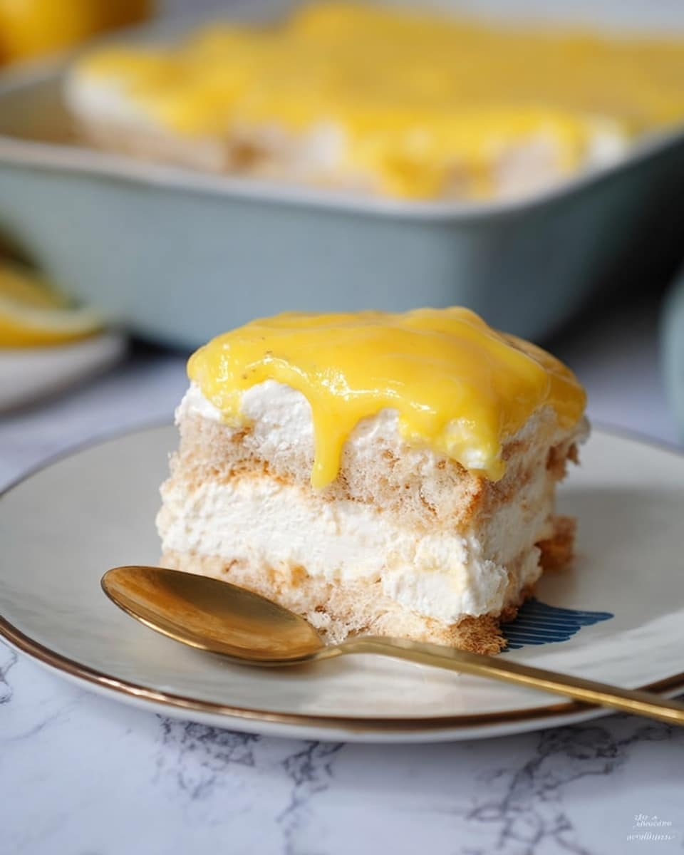 A square piece of dessert sits on a white plate with a blue section, showing three visible layers: the bottom layer is light tan with a soft, spongy texture, the middle layer is thick and white, creamy and fluffy, and the top layer is a smooth, bright yellow custard or sauce that slightly drips down the sides. There is a golden spoon placed next to the dessert on the plate, and in the background, a black baking pan with more of the dessert is visible, along with a whole lemon. The scene is set on a white marbled surface. photo taken with an iphone --ar 4:5 --v 7