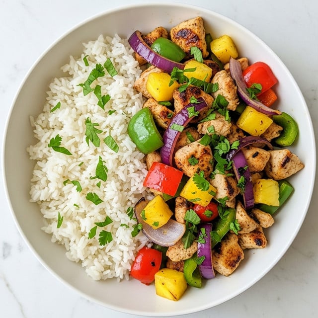 The image shows a close-up of a bowl with two main parts: on one side, there is white rice topped with small green herb pieces, and on the other side, there is cooked chicken cut into chunks, with a golden brown grilled texture and slight charring. Mixed well with the chicken are pieces of bright yellow pineapple, red and green bell pepper strips, and chunks of purple onion, all roasted with a shiny glaze and a sprinkle of green herbs for freshness. The bowl is white with a simple design, and the background is a white marbled texture. Photo taken with an iphone --ar 4:5 --v 7