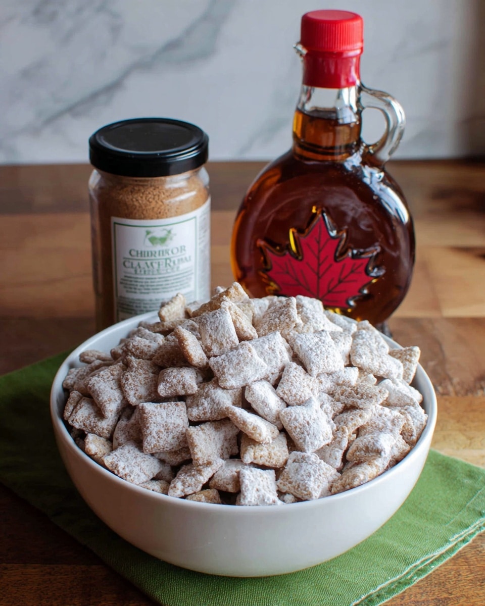 A large white bowl filled with many small, square cereal pieces covered in a light dusting of white powdered sugar, giving a soft and snowy look. Behind the bowl, there is a small jar with a black lid labeled cinnamon, with light brown powder inside, and a glass bottle filled with dark amber maple syrup, sealed with a red cap and a label featuring a red maple leaf. The bowl and items are placed on a wooden table with a green cloth napkin underneath, with a simple white marbled surface background. photo taken with an iphone --ar 4:5 --v 7