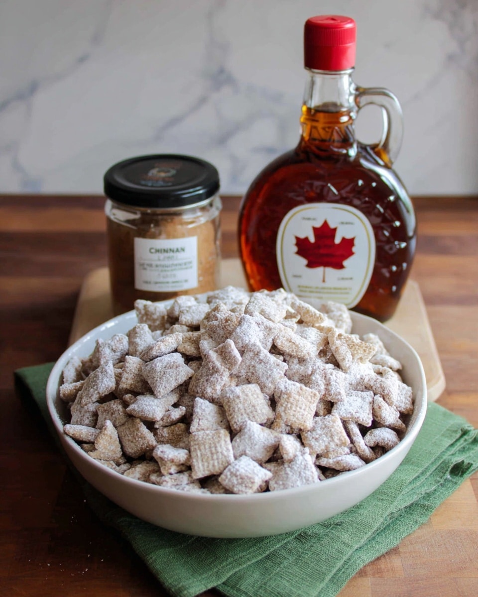 A white bowl filled to the top with small square cereal pieces coated in a light white powder, arranged loosely so you can see some gaps between the pieces. Behind the bowl, slightly to the right, there is a clear glass bottle of dark maple syrup with a red cap, and to the left of the bottle, a small jar with a black lid labeled as cinnamon. A green cloth is placed under the left side of the bowl, and the whole setup sits on a brown wooden table with a white marbled background. photo taken with an iphone --ar 4:5 --v 7