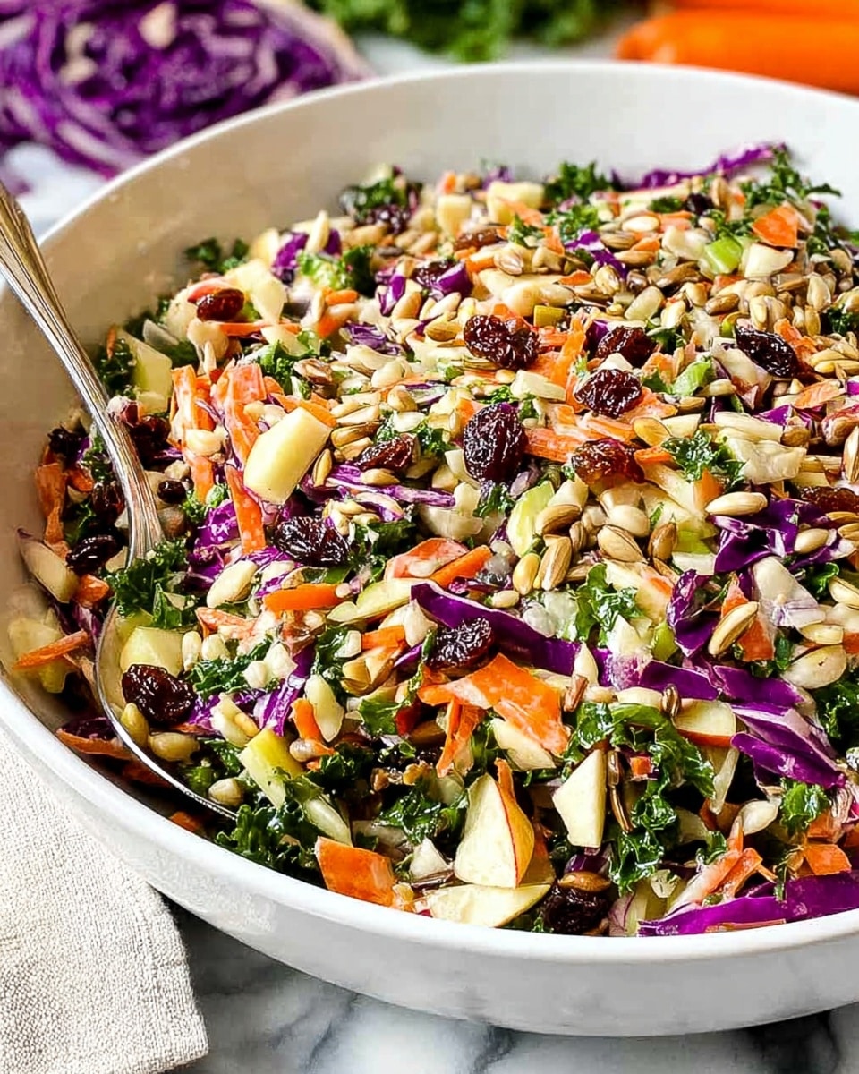 A white bowl filled with a colorful mixed salad showing layers of shredded light green and purple cabbage, bright orange carrot bits, green leafy herbs, dark red dried cranberries, and light brown sunflower seeds scattered on top. The textures are varied with crunchy seeds, tender cabbage, and chewy dried fruit, all well mixed together. The bowl sits on a white marbled surface with blurred fresh vegetables in the background. photo taken with an iphone --ar 4:5 --v 7